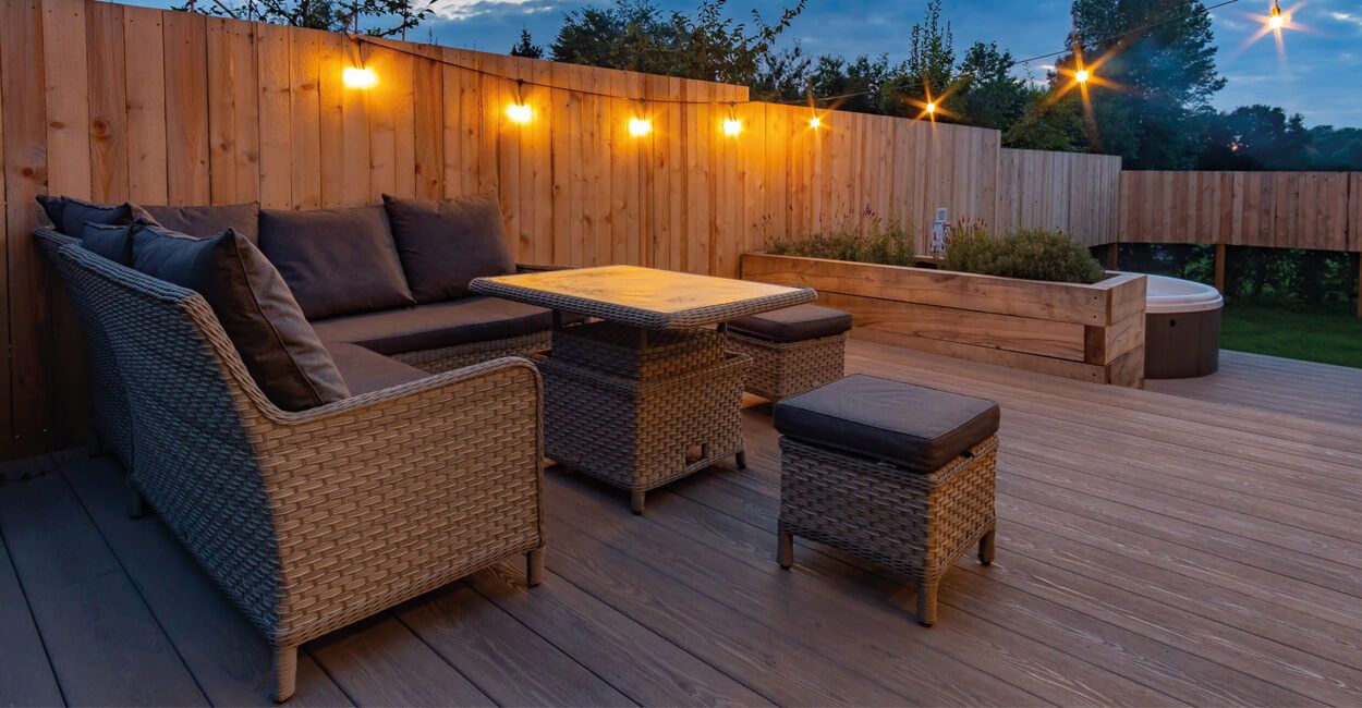 outside seating area on decking with string lights