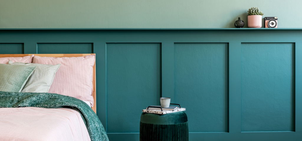 Panel behind a bed that protrudes from the wall as a shelf