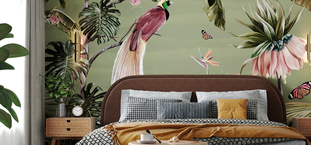 Bed in front of wallpaper featuring painted birds and plants