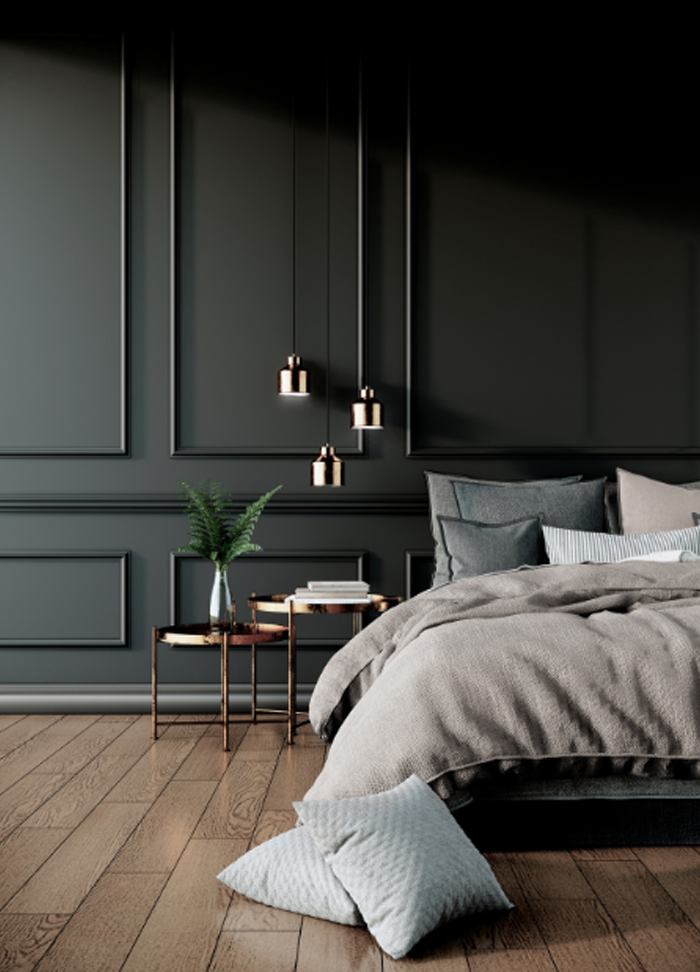 Black wall panels in rectangular shapes behind a bed