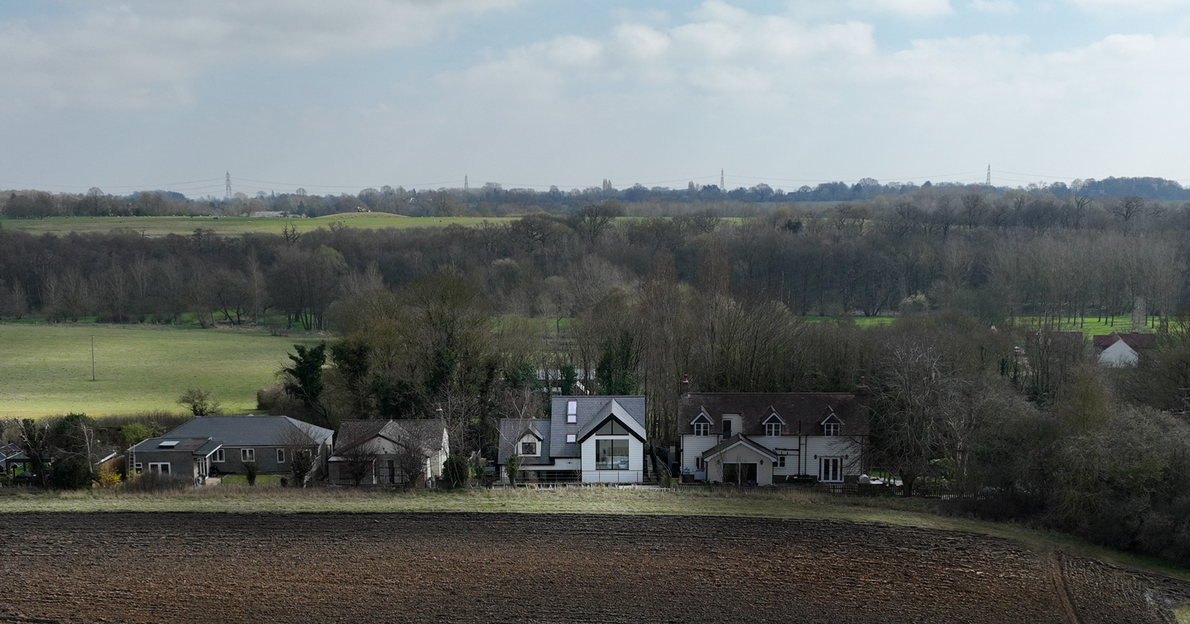 Drone shot of the house from afar, showing the contrast in cladding.