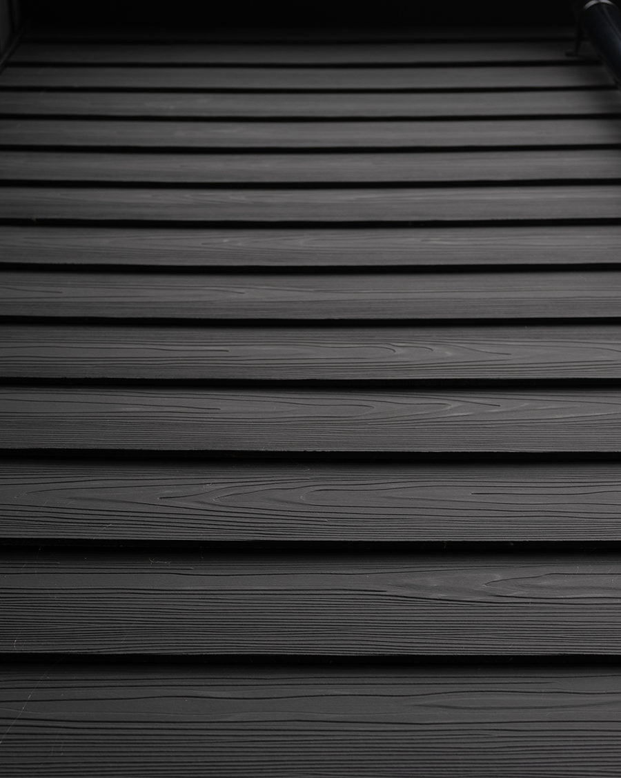 Cladco black fibre cement lap wall cladding after installation.