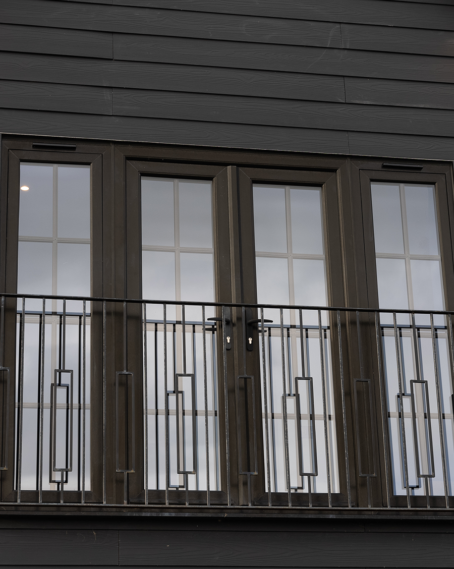 Front of house balcony wrapped in fibre cement lap cladding.