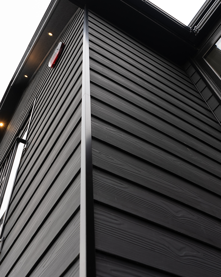A ground level view of the corner of the black house.