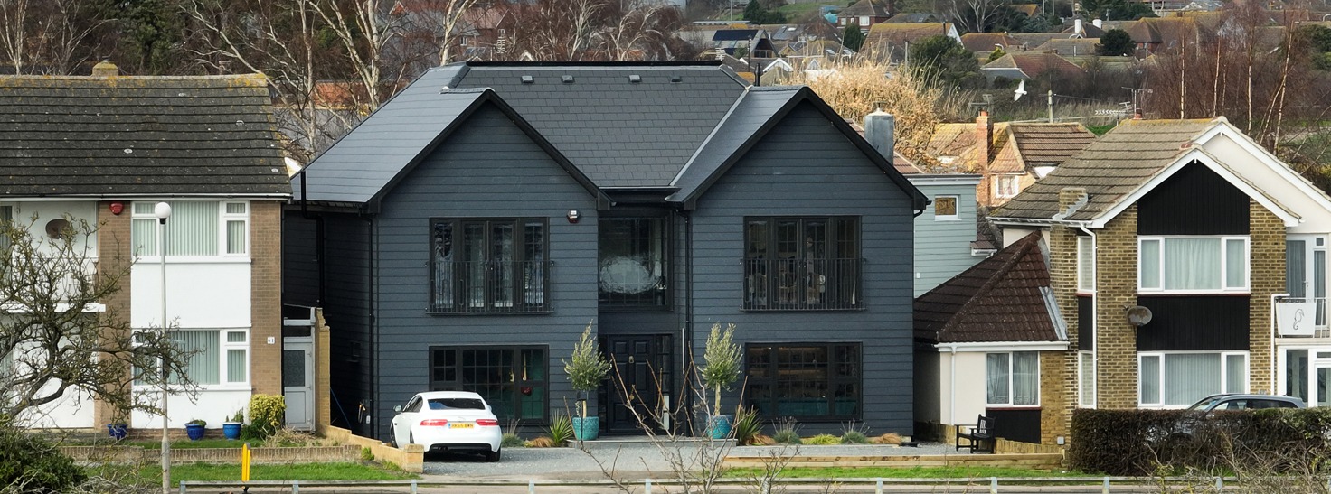 'The Black House' clad in Cladco black fibre cement lap cladding boards.
