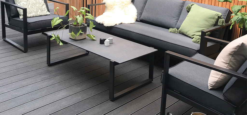 Narrow-grooved composite garden decking with a variety of potted plants
